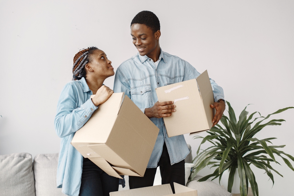 young-couple-moving-new-home-together-african-american-couple-with-cardboard-boxes (1)